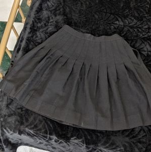 Pleated black school uniform skirt